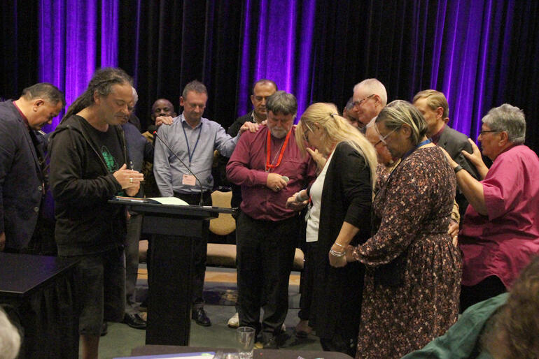 Bishops and delegates gather to pray for Archbishop Philip following the vote of thanks for his service as Te Hīnota Whānui president. Bishops and delegates gather to pray for Archbishop Philip following the vote of thanks for his service as Te Hīnota Whānui president.