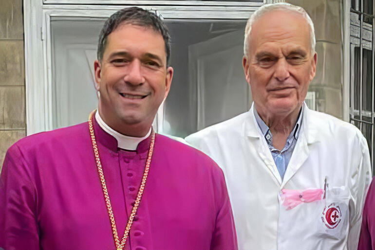 Medical Director of Al Ahli Hospital Dr Maher Ayyad stands with Archbishop Hosam Naoum. Photo: Jerusalem and Middle East Church Assoc.