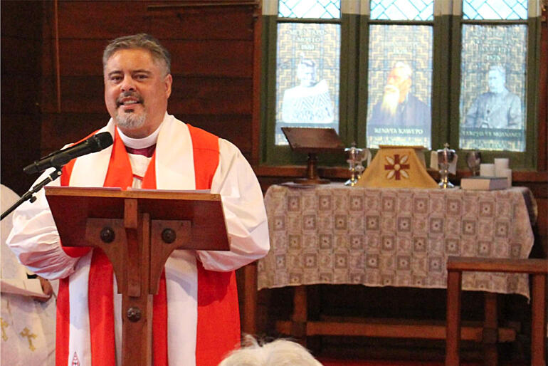 Archbishop Don Tamihere preaches at St John's Ōmāhu with three Ōmāhu tīpuna in the stained glass window behind him.
